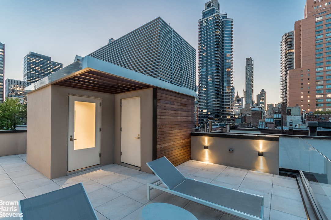 251 East 61st Street Manhattan, NY 10065 - Photo 5 of 39 a view of a swimming pool with outdoor seating