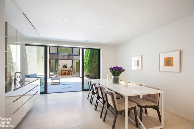 a view of a dining room with furniture large windows and wooden floor