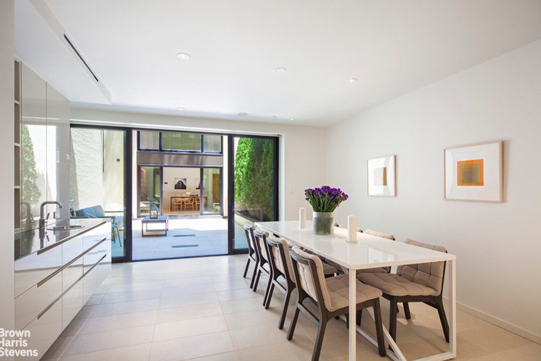 251 East 61st Street Manhattan, NY 10065 - Photo 6 of 39 a view of a dining room with furniture large windows and wooden floor
