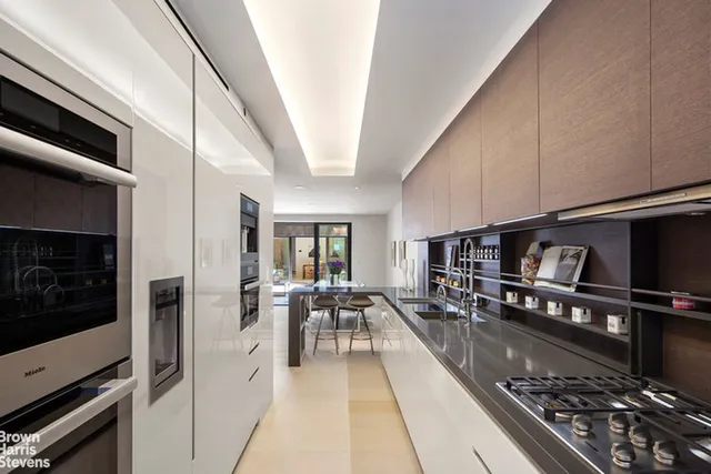 a kitchen with stainless steel appliances granite countertop a stove and a refrigerator