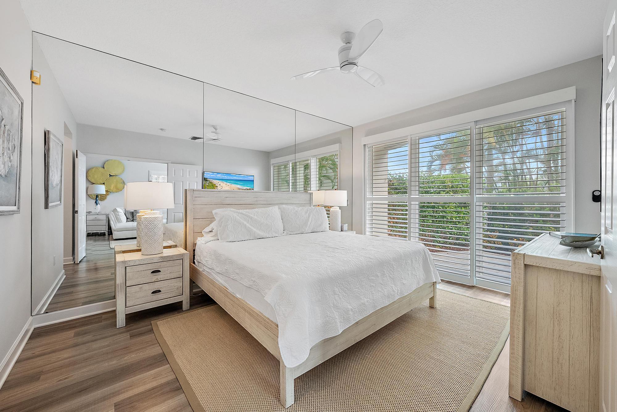 1000 North Us Highway, Unit 700 Jupiter, FL 33477 - Photo 12 of 32 a bedroom with a large bed and a window