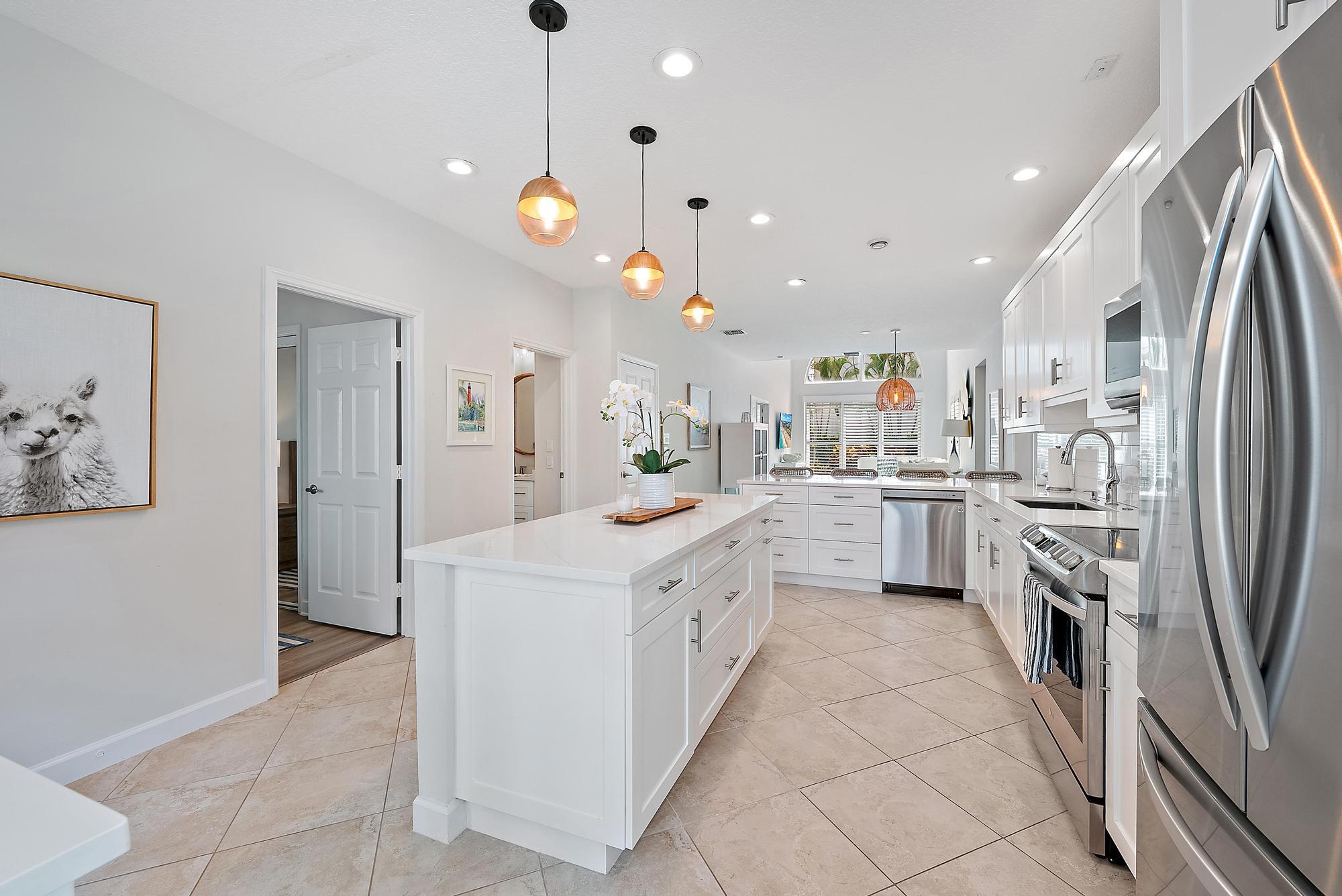 1000 North Us Highway, Unit 700 Jupiter, FL 33477 - Photo 4 of 32 a kitchen with white cabinets and stainless steel appliances