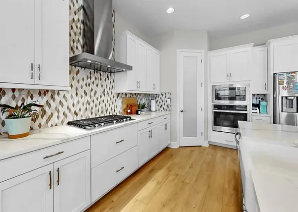 a view of kitchen with dining room and wooden floor