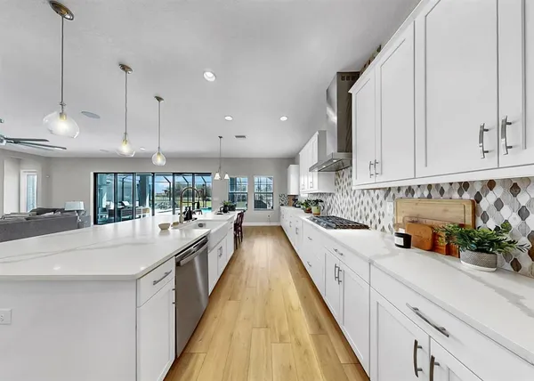 a living room with furniture and kitchen