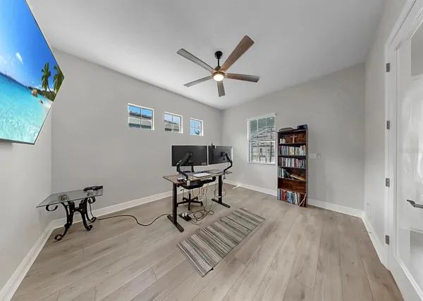 a living room with furniture and a wooden floor