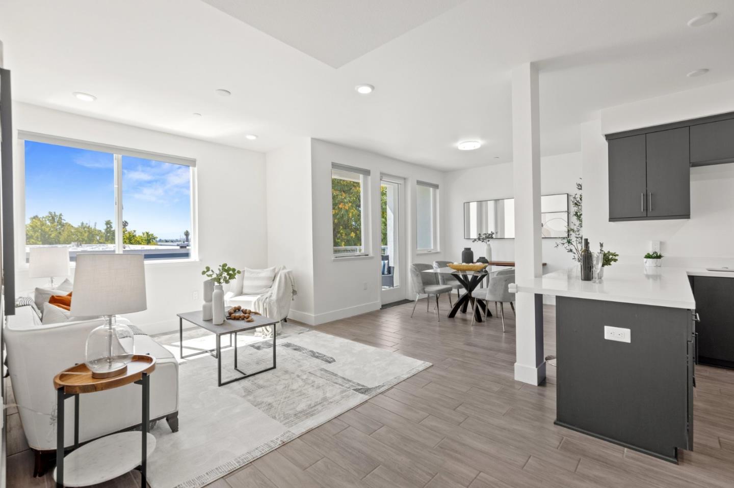 42111 Osgood Road, Unit 215 Fremont, CA 94539 - Photo 12 of 44 a living room with furniture and a dining table with kitchen view