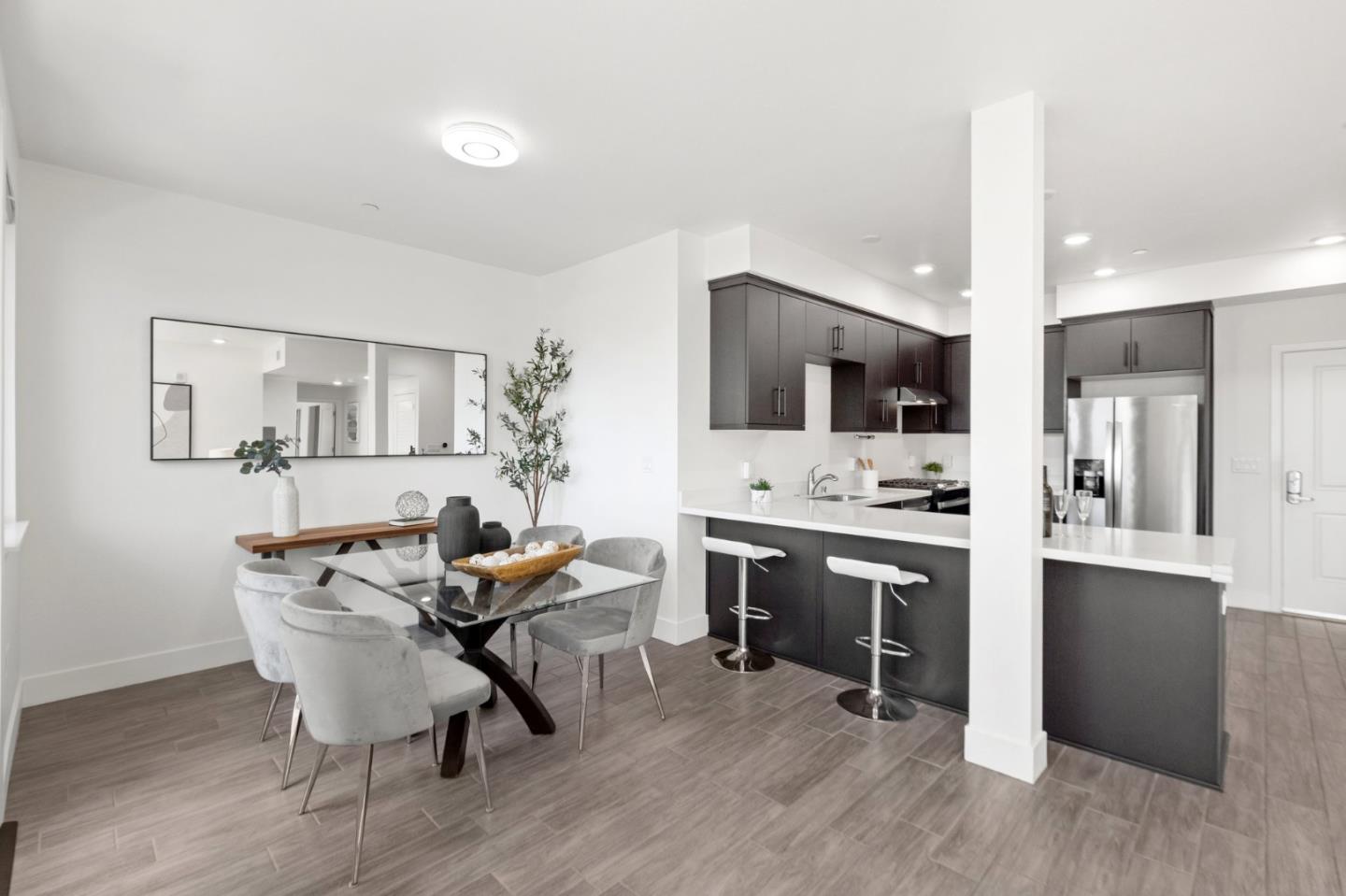 42111 Osgood Road, Unit 215 Fremont, CA 94539 - Photo 13 of 44 a view of a dining room with furniture and wooden floor