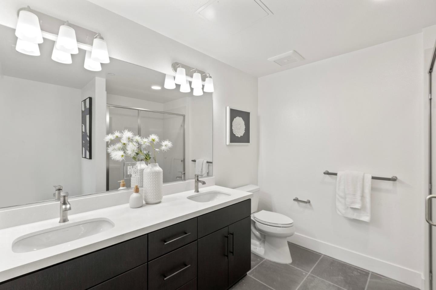 42111 Osgood Road, Unit 215 Fremont, CA 94539 - Photo 23 of 44 a bathroom with a toilet a sink and mirror