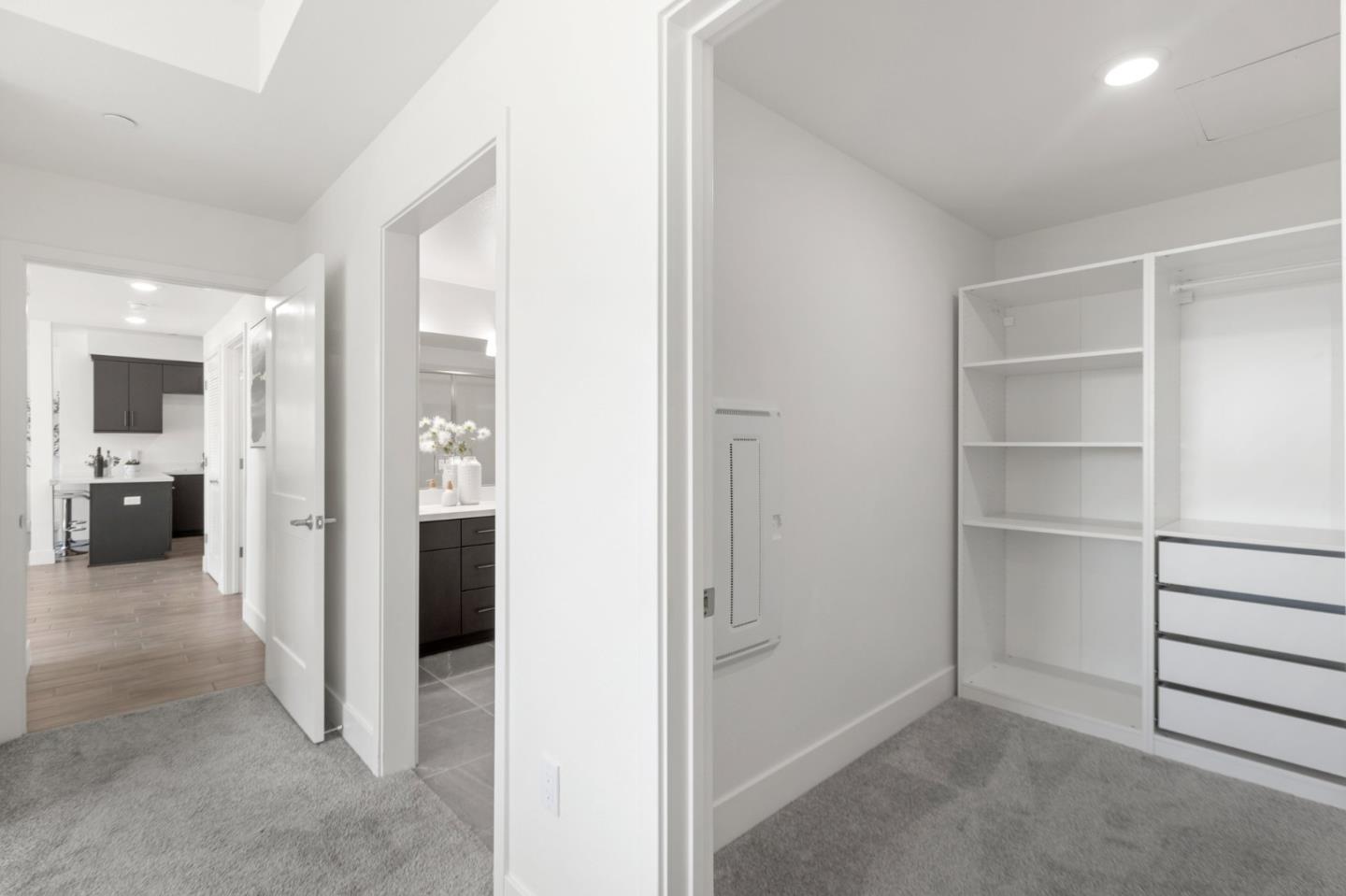 42111 Osgood Road, Unit 215 Fremont, CA 94539 - Photo 25 of 44 a view of a hallway with an empty room and a kitchen