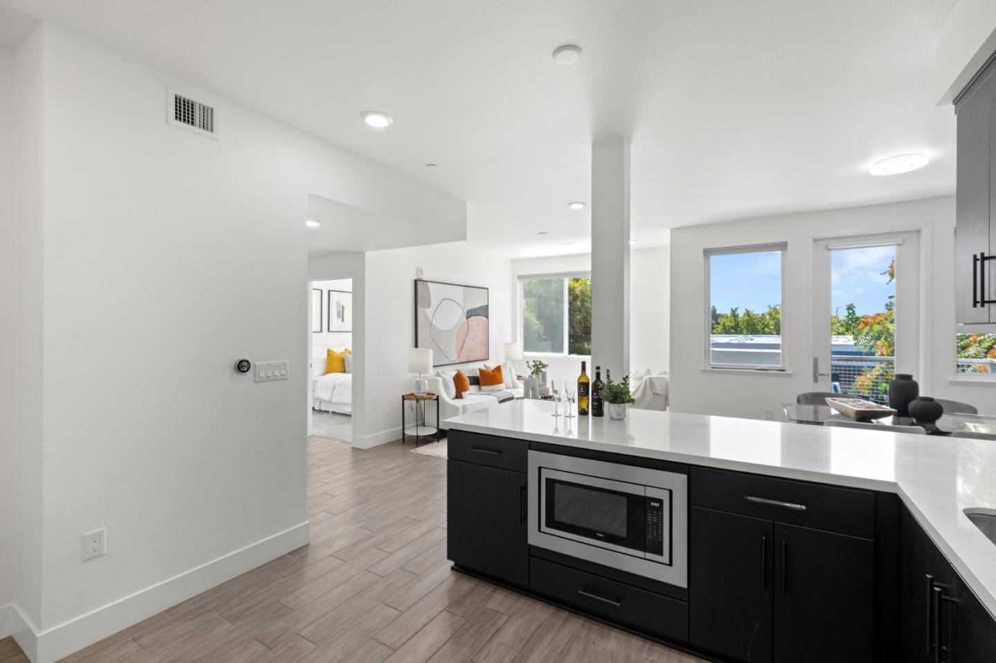 42111 Osgood Road, Unit 215 Fremont, CA 94539 - Photo 6 of 44 a kitchen with stainless steel appliances a sink dishwasher and a stove with wooden floor