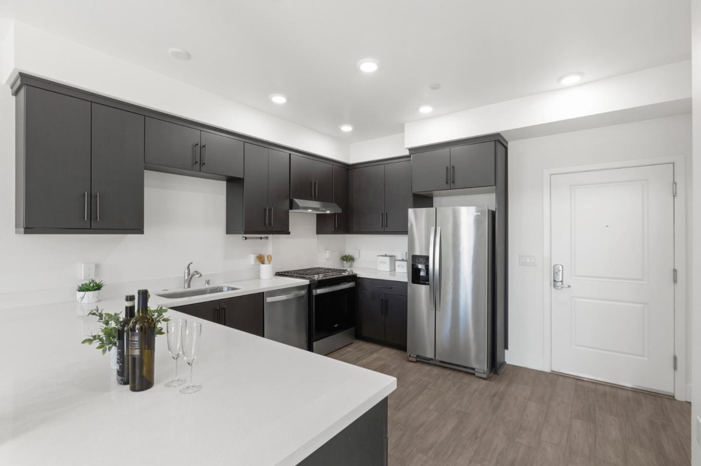 42111 Osgood Road, Unit 215 Fremont, CA 94539 - Photo 8 of 44 a kitchen with stainless steel appliances granite countertop a sink a stove a refrigerator and cabinets