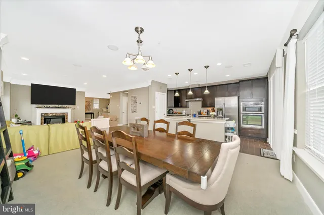 a view of a dining room with furniture and a kitchen