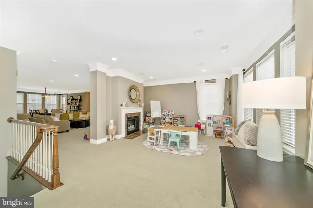 a living room with furniture a flat screen tv and a table
