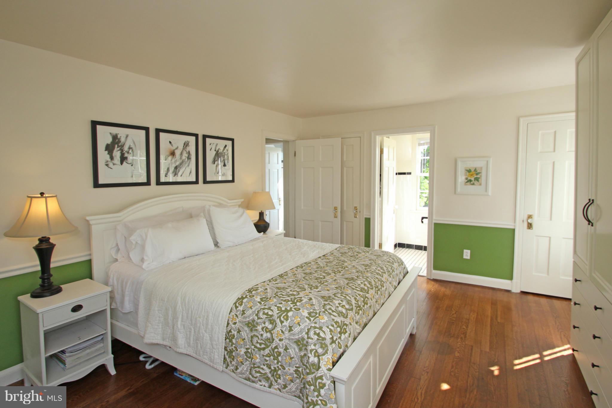 10314 Naglee Road Silver Spring, MD 20903 - Photo 16 of 30 a spacious bedroom with a bed and a lamp on table