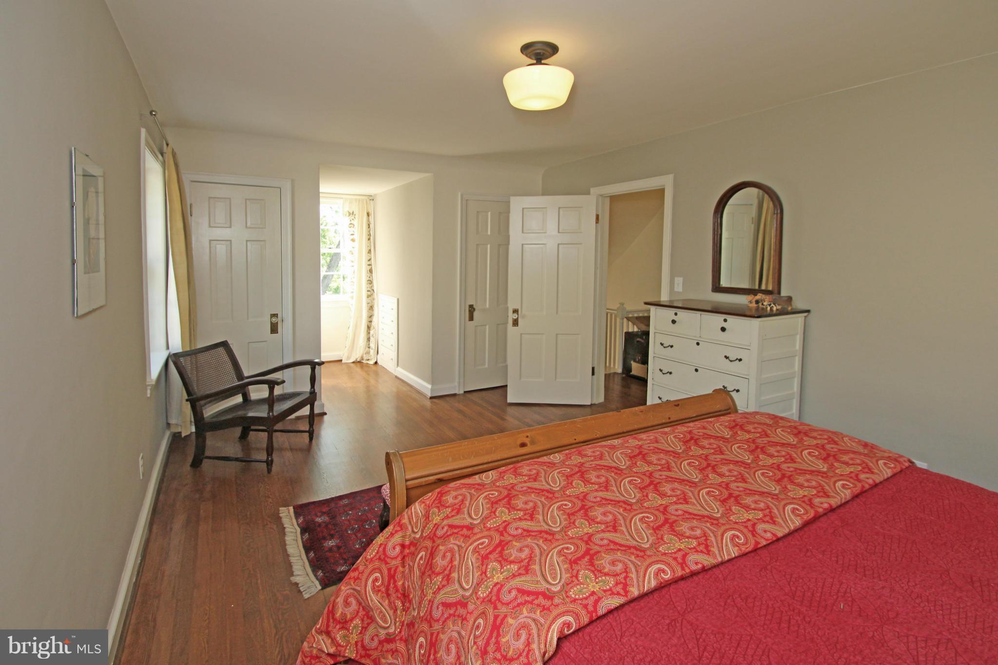10314 Naglee Road Silver Spring, MD 20903 - Photo 19 of 30 a bedroom with a bed and wooden floor
