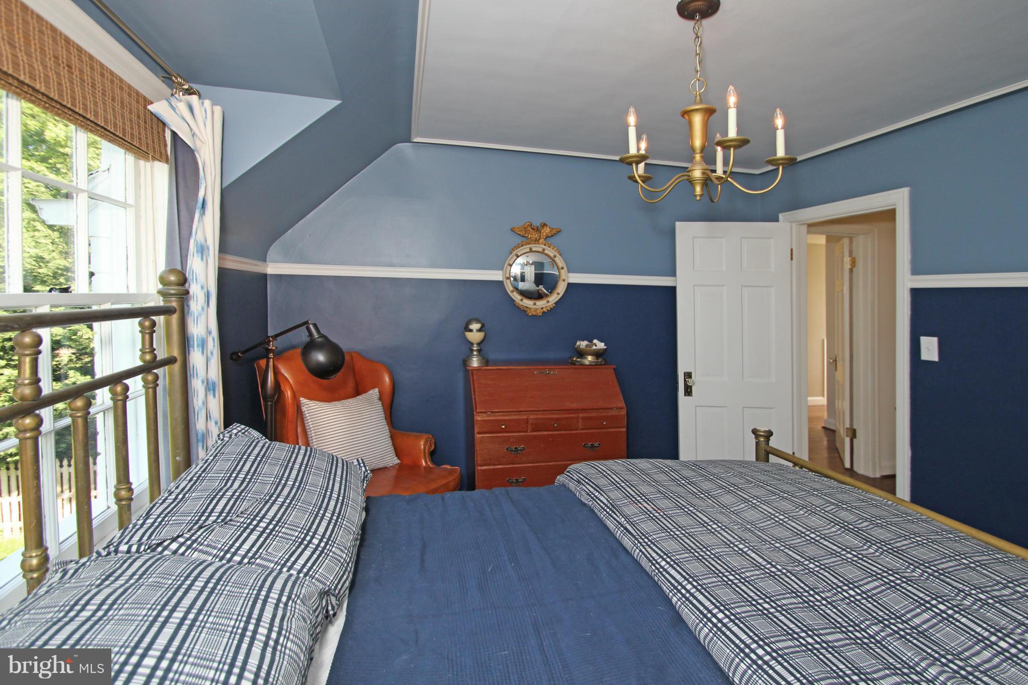 10314 Naglee Road Silver Spring, MD 20903 - Photo 21 of 30 a bedroom with a bed and a dresser next to a window