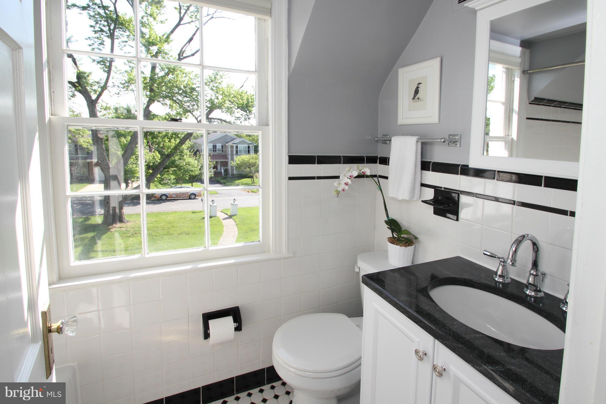 10314 Naglee Road Silver Spring, MD 20903 - Photo 22 of 30 a bathroom with a granite countertop sink mirror vanity and a toilet