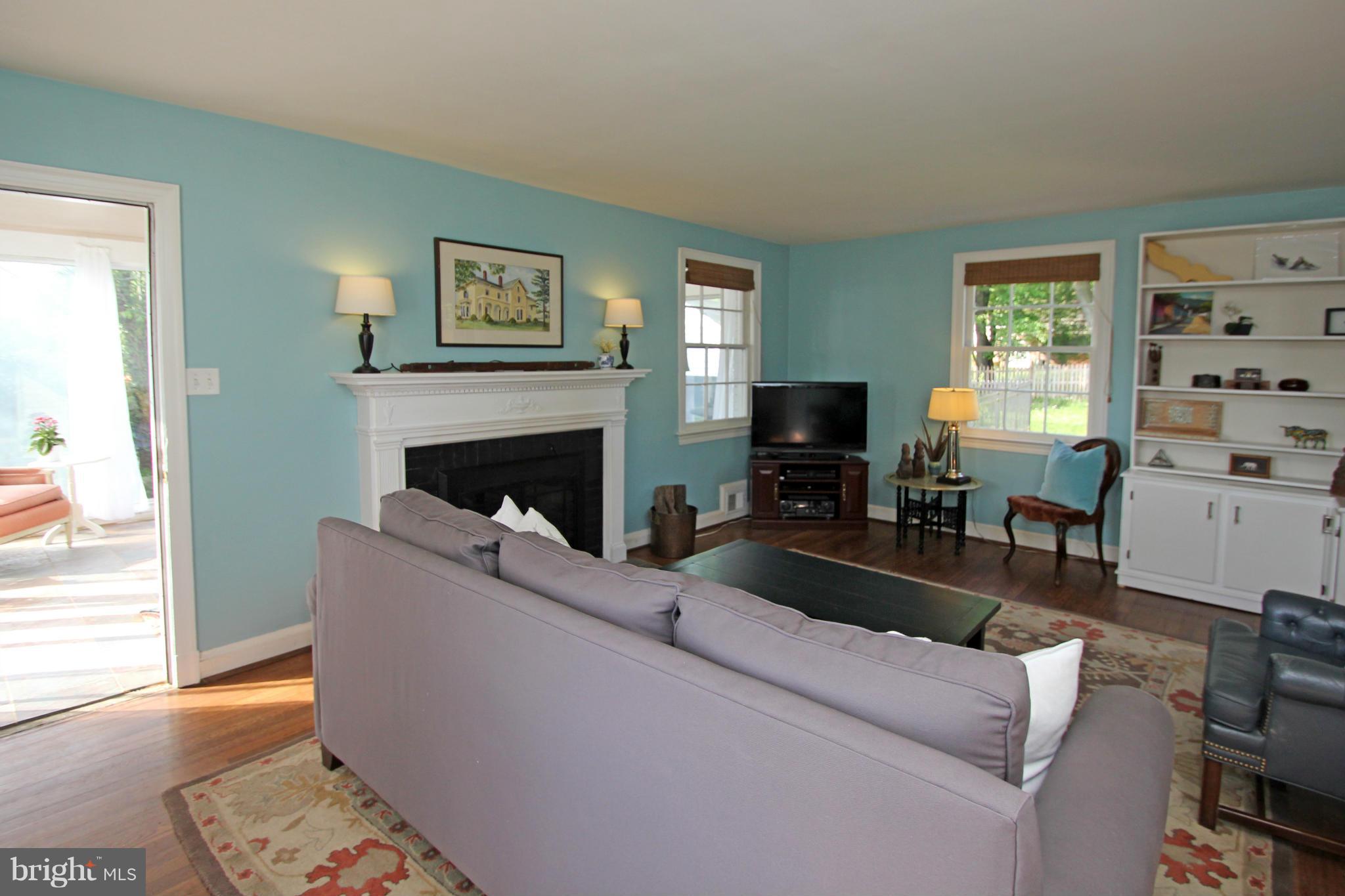10314 Naglee Road Silver Spring, MD 20903 - Photo 4 of 30 a living room with furniture a flat screen tv and a fireplace