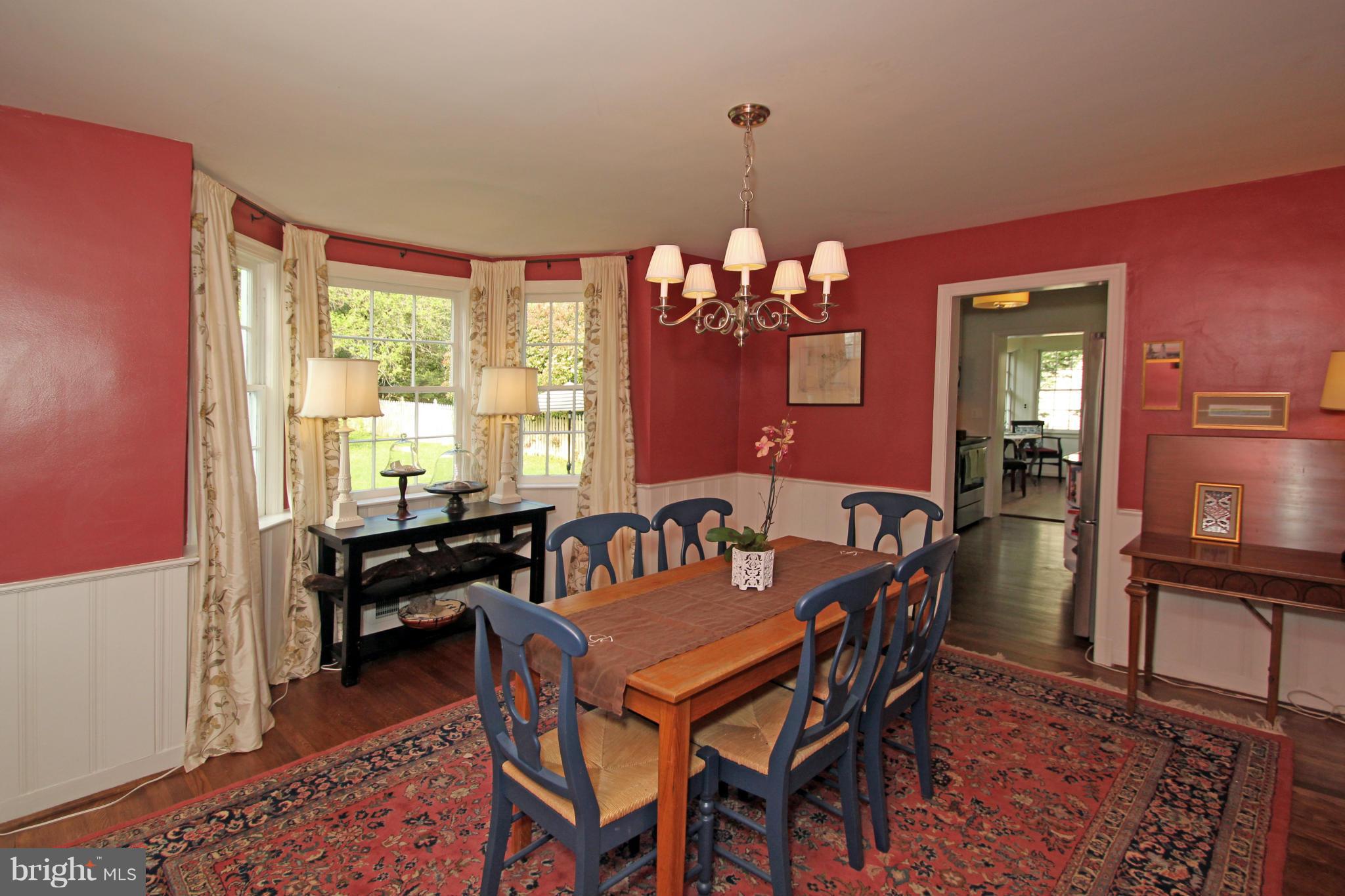 10314 Naglee Road Silver Spring, MD 20903 - Photo 8 of 30 a dining room with furniture a chandelier and wooden floor