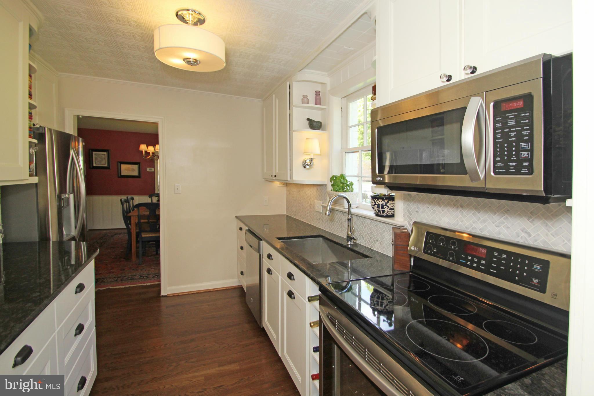 10314 Naglee Road Silver Spring, MD 20903 - Photo 10 of 30 a kitchen with stainless steel appliances granite countertop a stove and a microwave