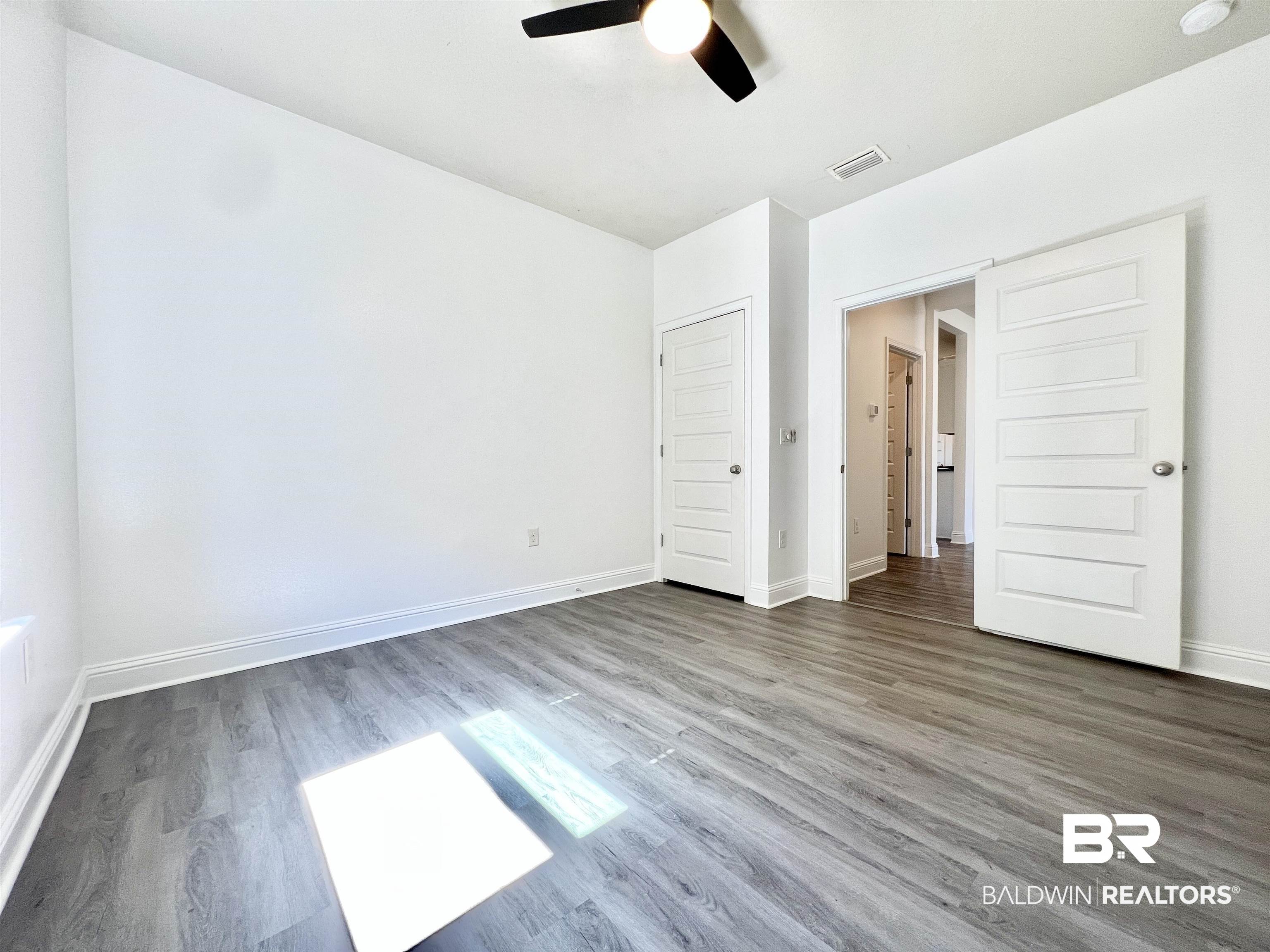 24785 Slater Mill Road Daphne, AL 36526 - Photo 22 of 46 Unfurnished bedroom featuring dark wood-type flooring and ceiling fan