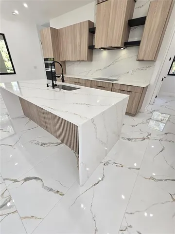 a kitchen with a sink and cabinets