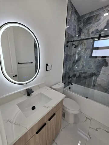 a bathroom with a toilet and shower