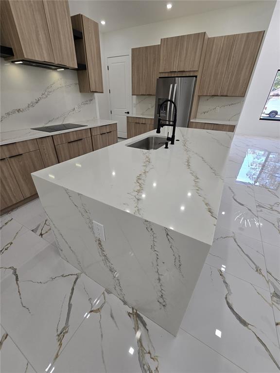 5823 Whippoorwill Drive Tampa, FL 33625 - Photo 9 of 31 a kitchen with stainless steel appliances a sink a refrigerator and cabinets