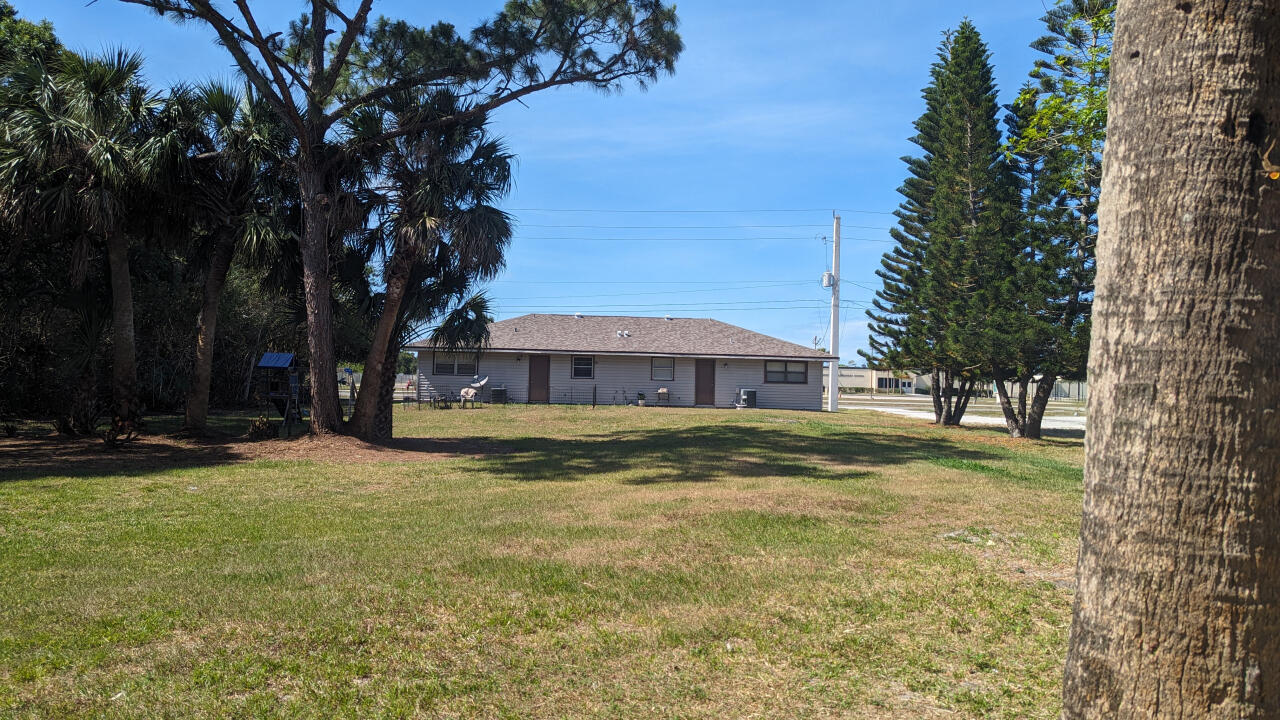 809 East Weatherbee Road Fort Pierce, FL 34982 - Photo 9 of 12 a view of a house with a yard