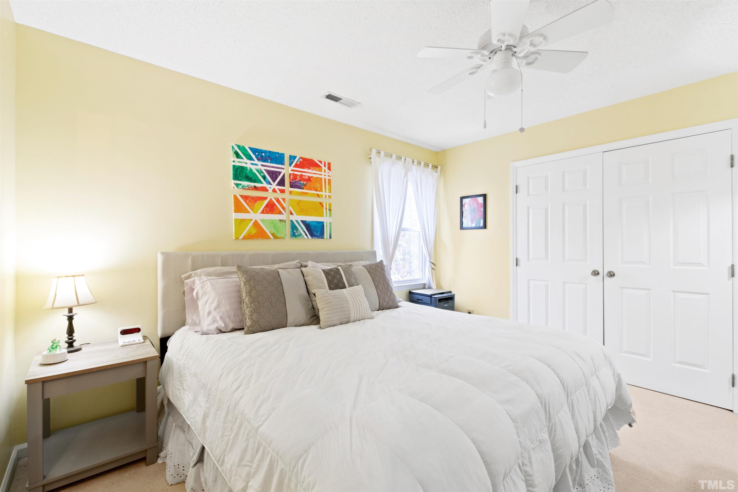 2704 Westhampton Place Raleigh, NC 27604 - Photo 33 of 47 a bedroom with a bed and a chandelier