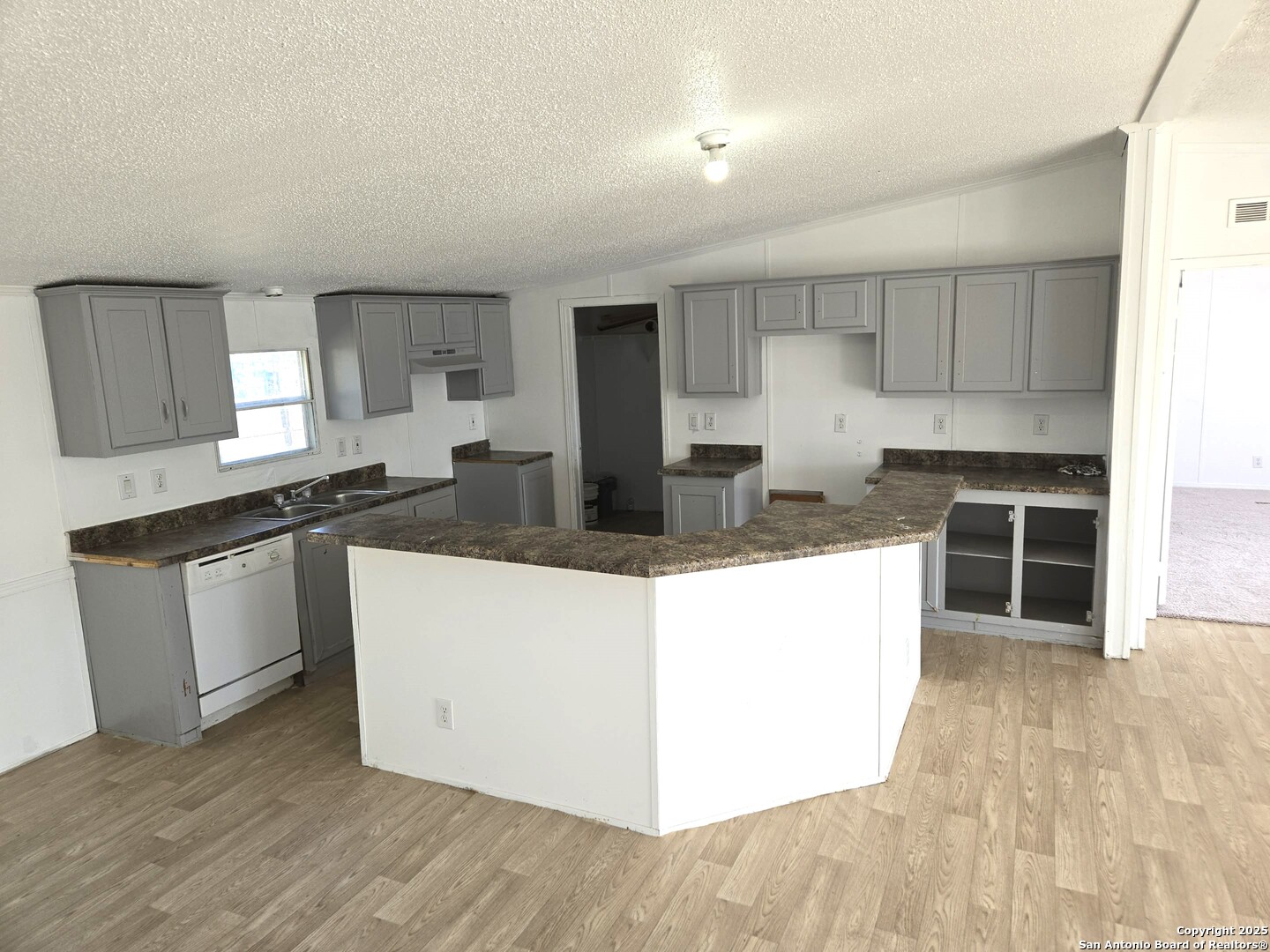 4124 Farmview Loop Converse, TX 78109 - Photo 5 of 19 a kitchen with granite countertop a stove a sink and a refrigerator