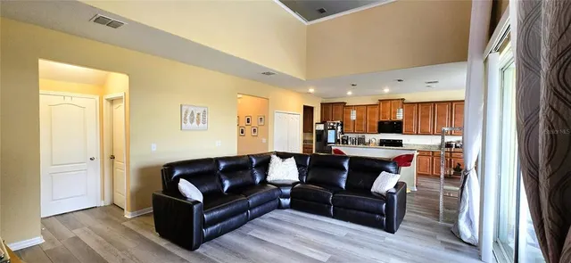 a view of living room kitchen with furniture and wooden floor