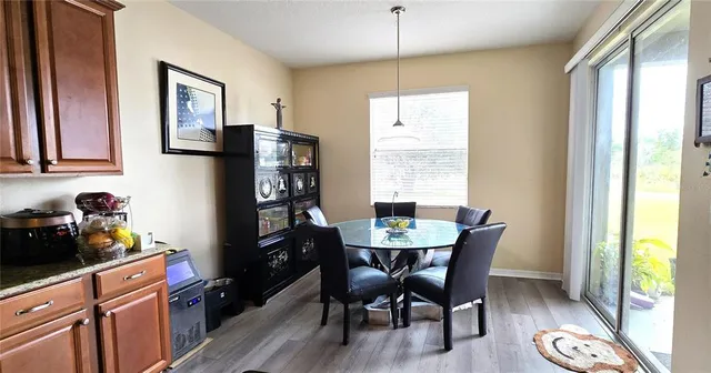 a view of a dining room with furniture window and wooden floor