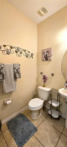 a bathroom with a toilet a sink and a mirror