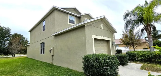 a house that has a tree in front of the house
