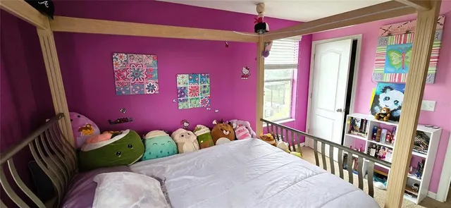 a bedroom with furniture and a book shelf