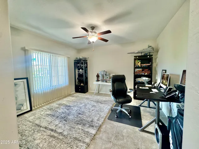 a view of a workspace with furniture and a window