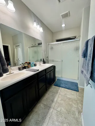 a bathroom with a sink double vanity and a mirror