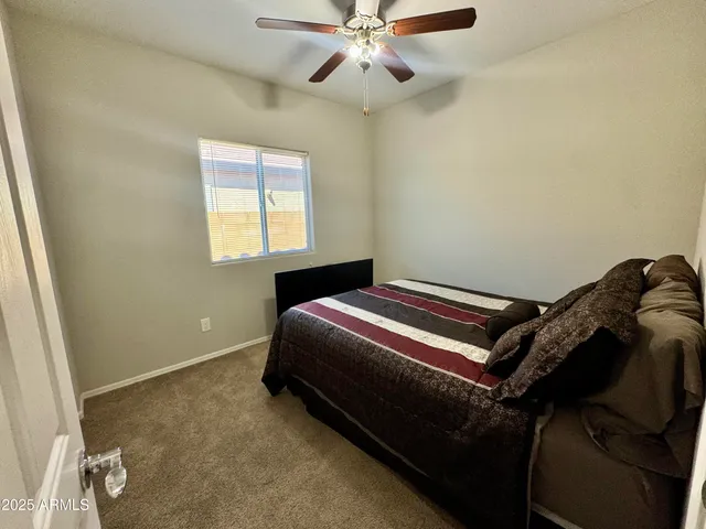 a bedroom with a bed and window