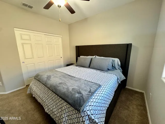a bedroom with a bed and lamp