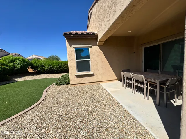 a view of a backyard with sitting area