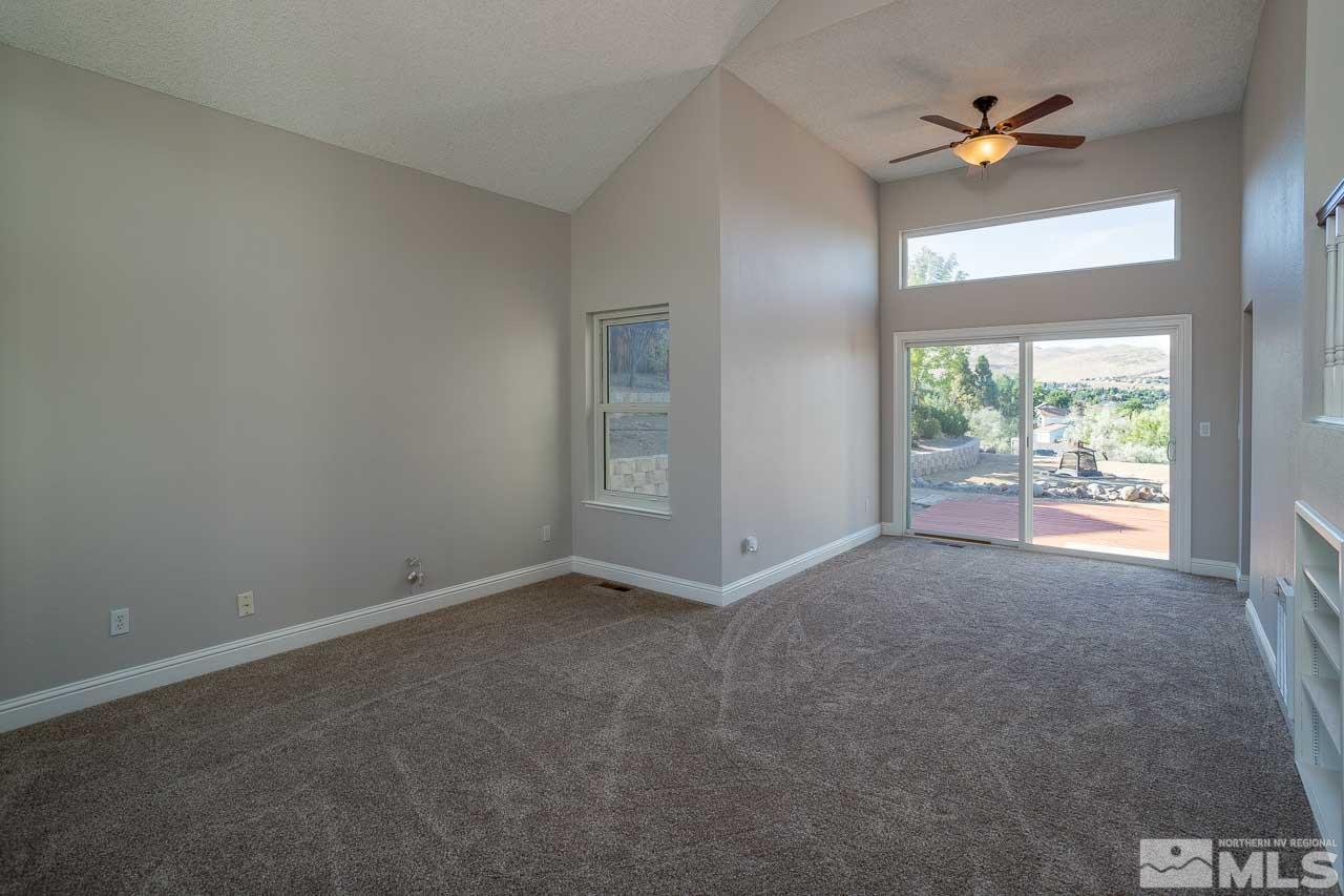 5217 Simons Drive Reno, NV 89523 - Photo 8 of 18 an empty room with a window and a ceiling fan