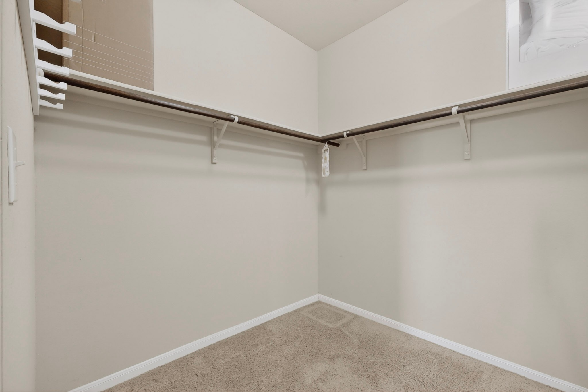 14513 Esker Road Manor, TX 78653 - Photo 28 of 38 Master Bedroom ,Ample hanging and shelf storage define this functional and tidy walk-in closet.