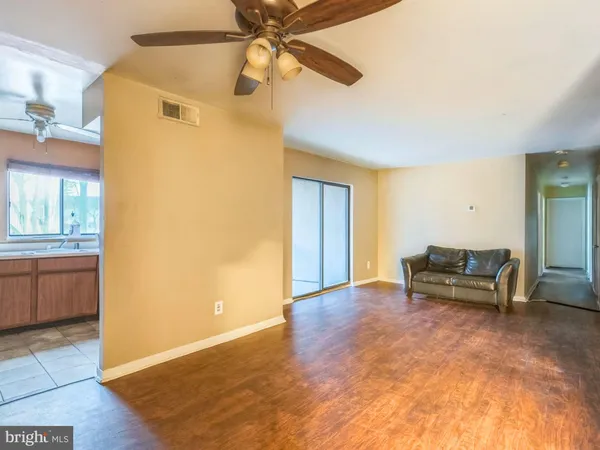 a view of livingroom with furniture and a chandelier fan