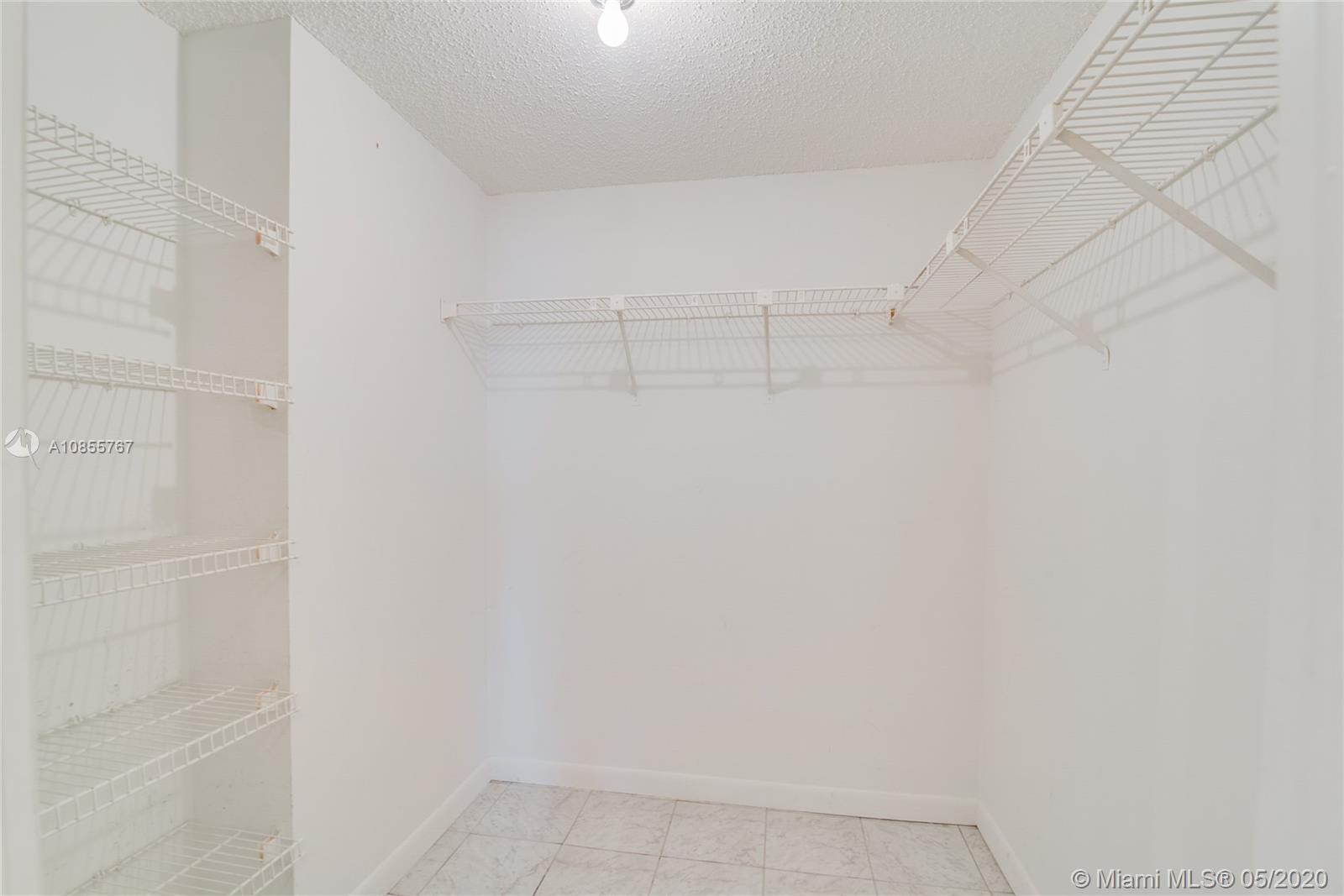 900 Northeast 195th Street, Unit 610 Miami, FL 33179 - Photo 11 of 15 His or hers walking closet
