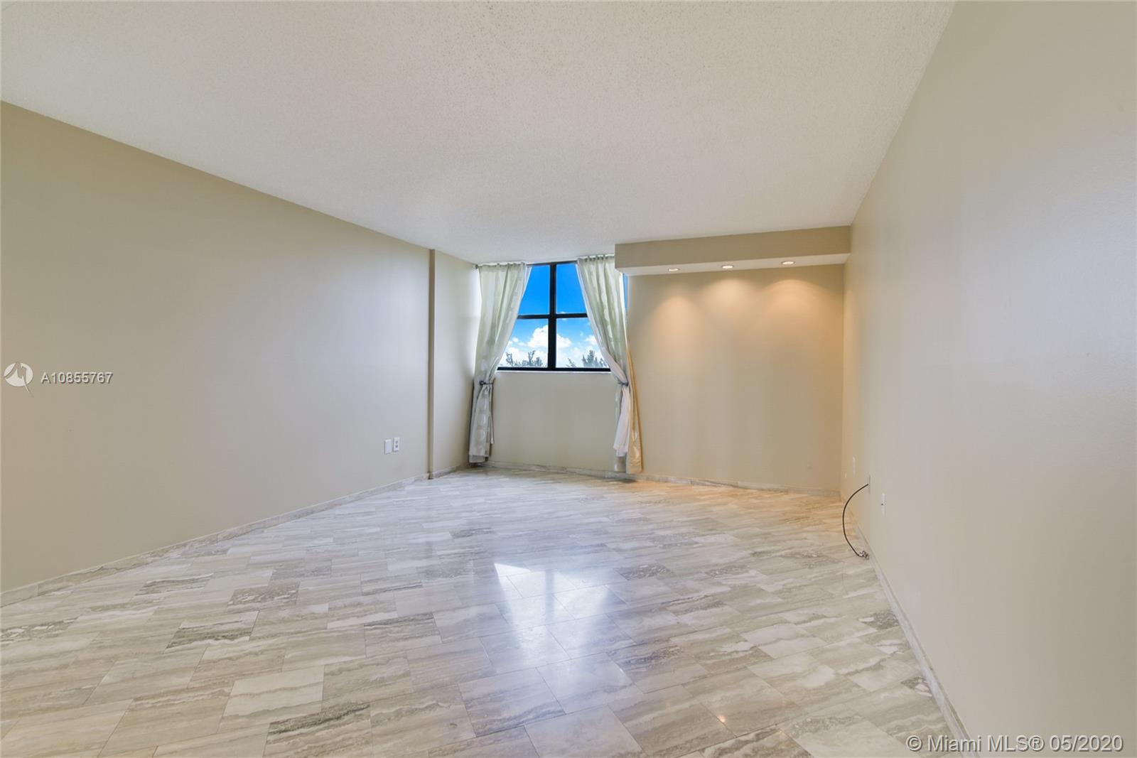 900 Northeast 195th Street, Unit 610 Miami, FL 33179 - Photo 4 of 15 Large master bedroom with his and hers walking closet