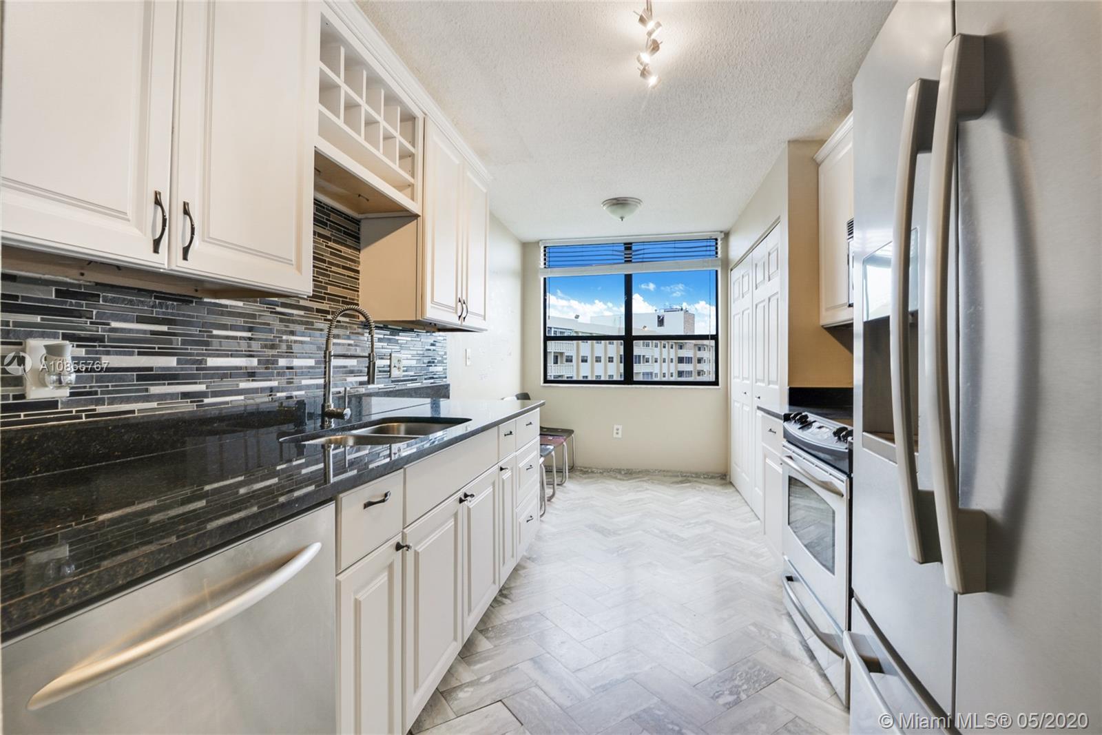 900 Northeast 195th Street, Unit 610 Miami, FL 33179 - Photo 5 of 15 Renovated kitchen with granite counter top, new appliances, breakfast area, and a large pantry
