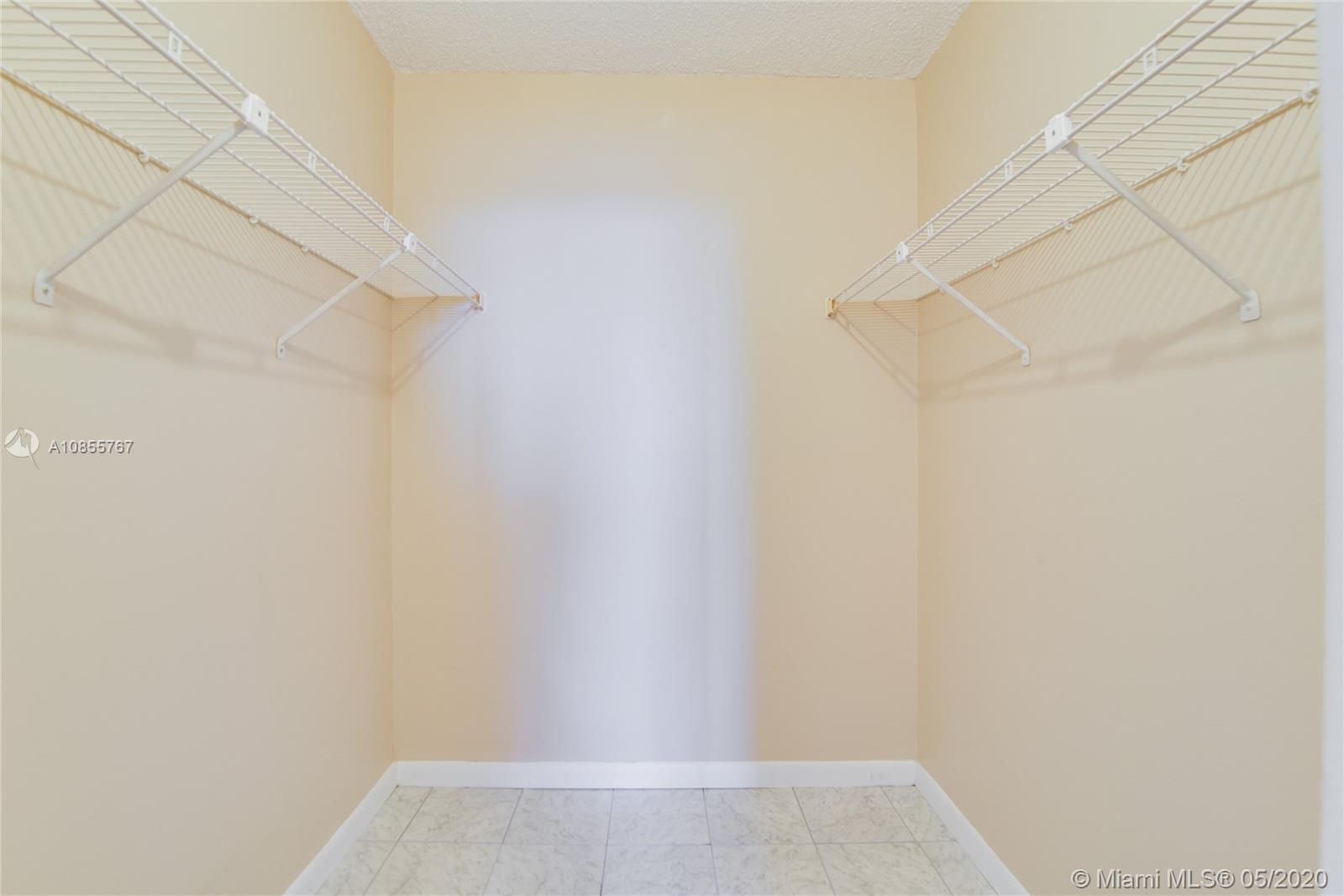 900 Northeast 195th Street, Unit 610 Miami, FL 33179 - Photo 9 of 15 Second bedroom walking closet