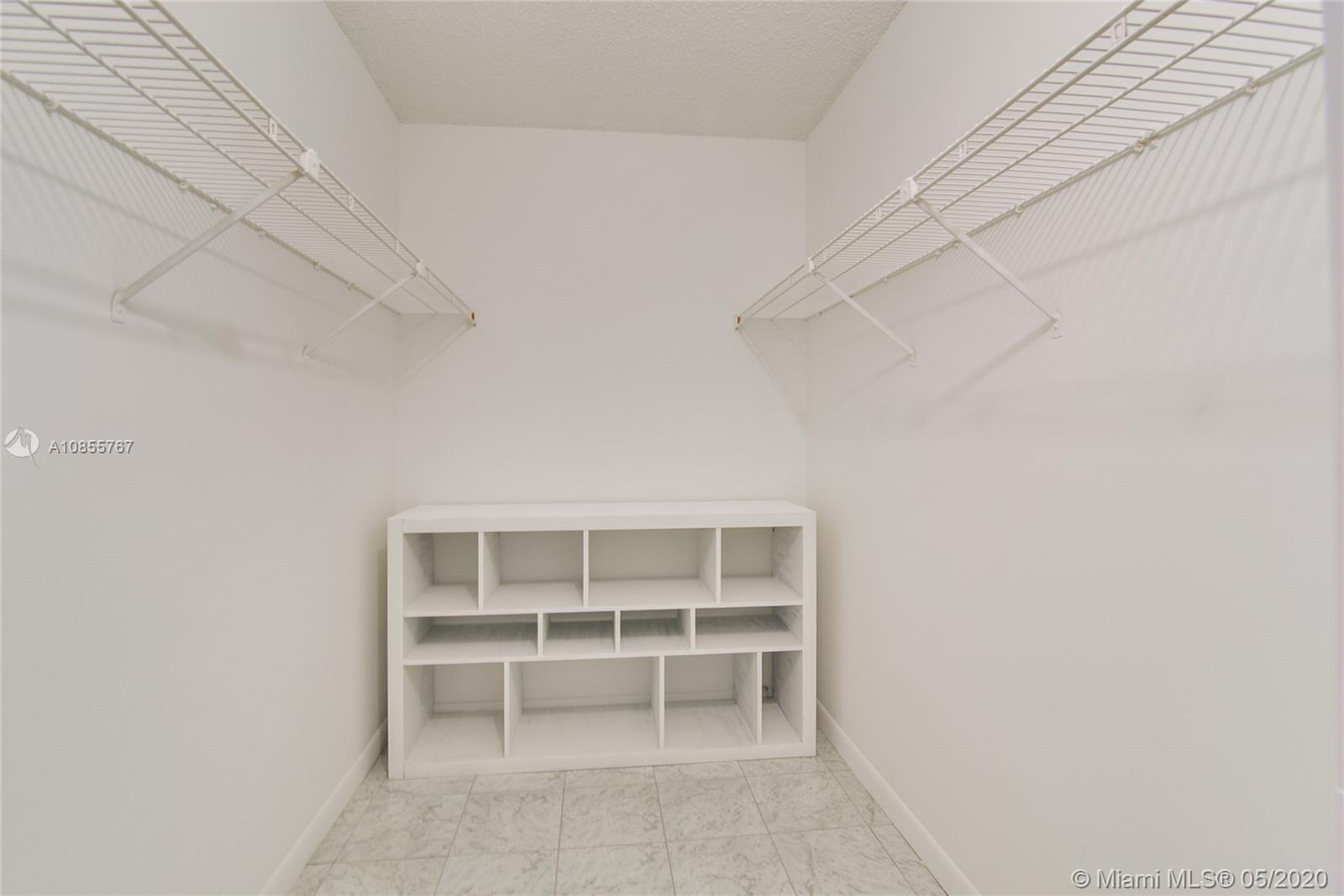 900 Northeast 195th Street, Unit 610 Miami, FL 33179 - Photo 10 of 15 His or Hers Walking closet