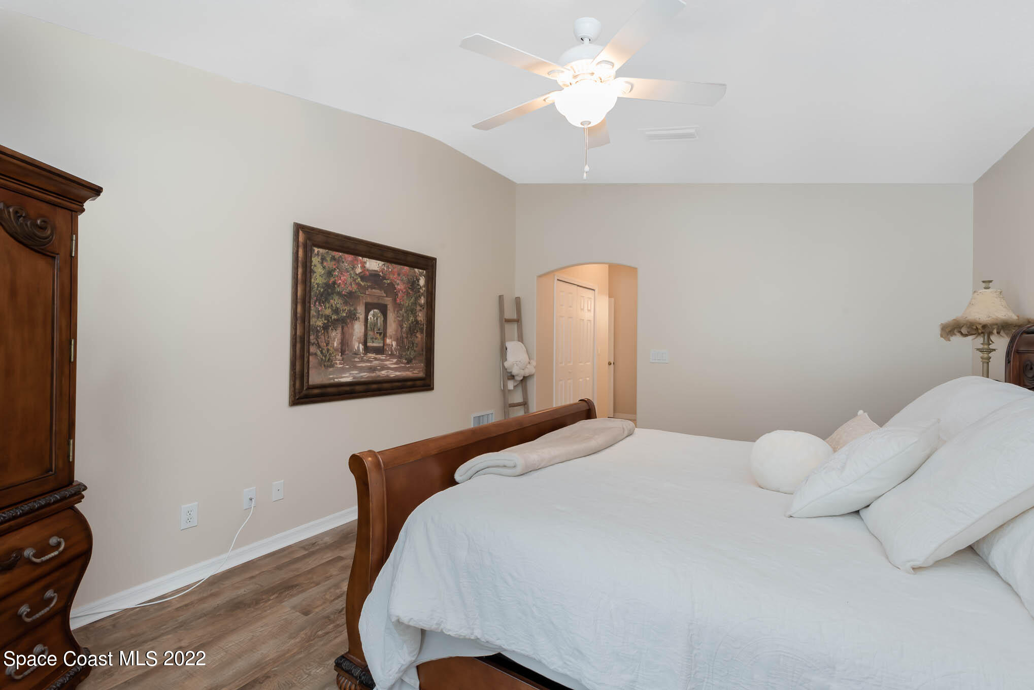 1063 Brumpton Place Rockledge, FL 32955 - Photo 12 of 33 a bedroom with a bed and a chandelier